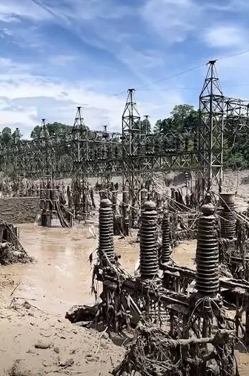 Switchyard equipment at the Nuwakot solar project's interconnection point, caked in mud after the flood