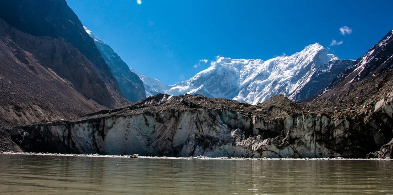 Trakarding Glacier calving directly into Tsho Rolpa, Nepal's largest and most closely watched glacial lake, with snow covered peaks behind it